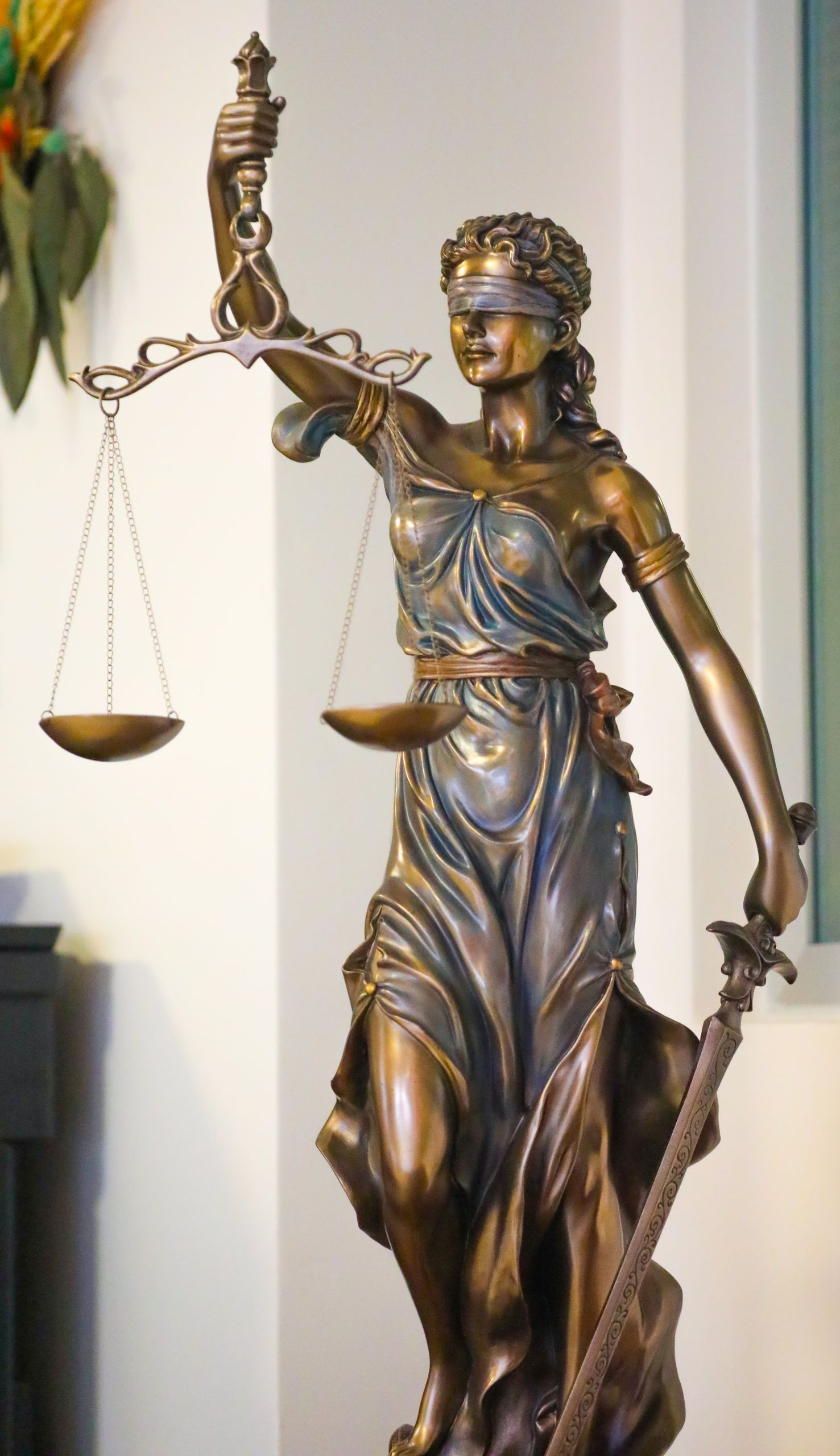 Bronze Lady Justice statue with scales and sword, symbolizing law and fairness, displayed indoors in İstanbul.